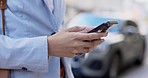 Phone, city and closeup of hands typing a text message, networking on social media or the internet. Technology, browsing and woman browsing on a mobile app with a cellphone in an urban town street.