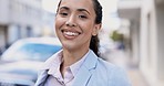 Happy, face and a woman in a city with wind, smiling and looking cheerful for work. Smile, beautiful and portrait of a young girl in town for corporate career, laughing and standing in an urban area