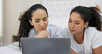 Bedroom, laptop and. couple of friends with website choice, decision or planning together on streaming service at home. Thinking, conversation and computer of lesbian women or people talking on bed