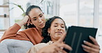 Lesbian couple, tablet and home sofa together to relax or surfing internet while talking and happy. Gay women with mobile app for streaming movies or video on social media living room couch with love