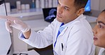 Doctor, coaching and training intern on computer in healthcare, science or research at the laboratory. Man medical professional helping female employee with scientific data on desktop PC at the lab