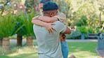 Love, reunion and interracial couple in park hug, smile and happy together in nature on summer weekend. Happiness, man and woman in garden sun, bonding embrace and support with trust in relationship.