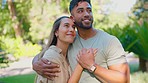 Love, relax and happy interracial couple in park for bonding, quality time and calm on weekend date. Relationship, dating and man and woman hug, embrace and kiss for care, commitment and romance