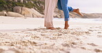 Couple, beach and feet in sand outdoor for love while romantic, happy and together on vacation or holiday. Young man and a woman legs at sea for time on a date, care and freedom on travel adventure