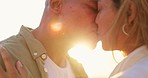 Love, beach kiss and couple face closeup by a sea with happiness and sunset for summer holiday trip. Ocean, date and happy people together with a loving and relax embrace with commitment outdoor