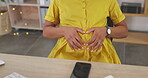 Touching belly, relax and a pregnant woman in the office, massaging stomach and break from work. Love, sitting and an employee feeling her tummy during pregnancy at the workplace for relaxation