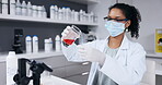 Scientist, woman and test tube with chemical, chemistry with beaker and science experiment in laboratory. Female doctor in face mask, PPE and red liquid, experiment for medical research in lab