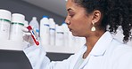 Scientist, woman and blood test tube in laboratory for research, testing or experiment. Doctor, science and person looking at medical sample or vial for dna analysis, examination or studying biology.