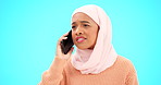 Muslim woman, phone call and angry, argument or conflict in studio isolated on a blue background mockup. Cellphone, discussion and frustrated Islamic person talking, upset and speaking or question.