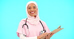 Woman, doctor and clipboard portrait in studio for information or medical records. Islamic or muslim female and professional nurse in hijab with smile and document for healthcare on blue background