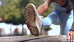 Stretching, legs and fitness of woman in park for muscle health, wellness and sports training outdoor. Shoes, foot and athlete, runner or person with warmup for workout in forest or outdoor exercise