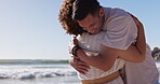 Hugging, beach and couple on a date at the sea or ocean together on holiday or summer vacation. Romantic, man and woman embrace for love, care and support or people in a relationship for happiness