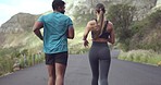 Fitness, running and couple of friends on road for cardio workout, exercise and training together by mountains. Personal trainer, sports woman or runner people jogging in rear outdoor for body health