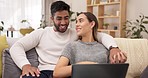 Laptop, relax and couple on sofa, happy and enjoy subscription or streaming service in their home. Love, smile and man and woman embrace while resting and watch online entertrainment in living room