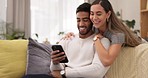 Phone, kiss and couple on sofa happy in home for bonding, quality time and relax in living room. Interracial relationship, love and man and woman on smartphone for social media, internet and website