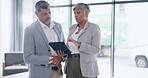 Business people, tablet and meeting for strategy, collaboration or planning together at the office. Businessman and woman discussing project plan, brainstorming or ideas on technology at workplace