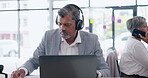 Headphones, laptop and business man writing in office listening to podcast, music or radio. Senior, computer and male professional streaming audio, sound or song and working in corporate workplace.