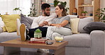 Couple, kiss and holding hands on home sofa with love, care and support or happiness and smile. Man and woman together on living room couch for bonding, relax and quality time or happy commitment