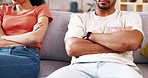 Conflict, fight and couple on sofa with crossed arms for argument, disagreement and relationship problem. Dating, divorce and man and woman on couch with upset, frustrated and angry gesture at home