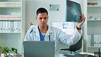 Medical x ray, man doctor and laptop for results and healthcare, surgery or health insurance. Male worker in a hospital with an mri scan and tech for analysis, internet connection and telehealth