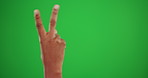 Peace sign, icon and hand of person on green screen for support, kindness and vote mockup. Review, symbol and positive with gesture isolated on studio background for happiness, greeting and emoji