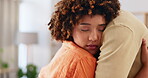 Love, care and support with a couple hugging in the living room of their home together for comfort or trust. Empathy, console or marriage with a man and woman embracing through pain, loss or grief