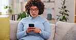 Serious, phone and relax with woman on sofa for social media, internet and text message. Search, typing and technology with female in living room at home for communication, connection and digital app