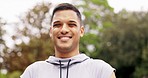 Happy, fitness and face of man in a park for sports, workout or morning run against blurred background. Smile, portrait and indian guy in forest for training, workout and cardio with positive mindset