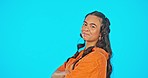 Happy, mockup and face of a woman with arms crossed isolated on a blue background in a studio. Smile, beautiful and portrait of a girl with pride, confidence and attitude on a backdrop with space