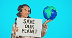 Portrait, poster and world with a woman on a blue background in studio holding a save our planet sign. Globe, earth day and protest with an attractive young female at a green rally for sustainability