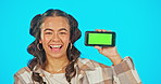 Phone, green screen and woman in studio advertising website, mobile app or network connection. Portrait of happy gen z female model laugh with smartphone in hand for brand or logo product placement