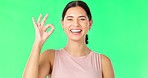 Face, green screen and woman with ok sign, perfect and happiness against a studio background. Portrait, female and happy person with hand gesture for approval, symbol for agreement and satisfaction