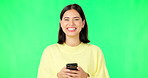 Smile, woman and smartphone on green screen, face and studio for social media, online contact and meme. Portrait of happy female model typing on cellphone, download mobile games or scroll for texting