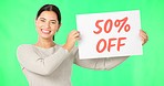 Woman, face and discount sign on green screen, smile and advertising with poster, store promotion and sale. Portrait, billboard and cardboard with text, happy female with notice on studio background