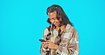 Phone, typing and woman laughing isolated on blue background for social media, funny meme and chat on mobile app. Happy gen z person with online communication, networking and mobile app in studio