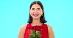 Bouquet of flowers, happy woman and face in studio, blue background and color backdrop. Portrait female model, roses and smile for floral gift of love, celebration and romantic care on valentines day