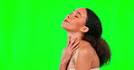 Beauty, skincare and touching with a woman on a green screen background in studio for wellness. Luxury, relax and health with an attractive young female rubbing her soft, smooth or silky skin