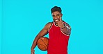 Basketball, man and thumbs up for success in sports isolated in studio on blue background mockup. Face portrait, happy person or ball spin with emoji for exercise goals, like or hand gesture for yes.