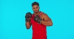 Face, boxer and man challenge in studio isolated on a blue background mockup. Portrait, boxing athlete and Indian person punching for fitness, exercise and training for fight, competition and sports.
