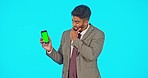 Green screen, phone and man thinking, doubt and decision for stock market or investment risk in studio mockup. Face of a business person, online choice and mobile app, isolated on blue background