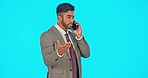 Phone call, talking and business man in studio isolated on a blue background mockup. Cellphone, conversation and serious Indian professional or person in discussion, negotiation or chat with contact.