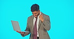 Success, winning and man on laptop isolated on blue screen cheers, celebration and fist pump for news, bonus and sales. Yes of happy winner or business person celebrate, wow and computer in studio