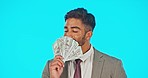 Business man, dollar fan and studio isolated on a blue background mockup. Cash, winning and face portrait of happy Indian person smell or sniff money after lottery, bonus prize or financial freedom.