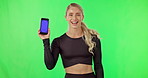 Woman, phone and thumbs up portrait on green screen for gym membership sign up on website. Happy athlete person with mobile device for exercise app, mockup and invite or like on studio background
