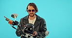 Sport, cool and motorcycle with man in studio for vintage, retro or transportation. Urban, leather and fashion with biker riding on motorbike and isolated on blue background for travel and attitude