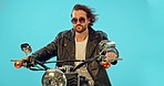 Man, fashion and motorbike in studio on blue background for road trip, adventure and leather aesthetic. Driving, motorcycle and man riding on mockup, edgy and confident, vintage and retro isolated