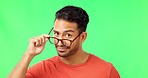 Glasses, face and man in a studio with green screen for optical awareness, wellness and health. Wink, flirt and portrait of an Indian male model with spectacles for eye care by chroma key background.