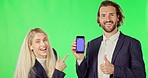 Business people, phone and mockup on green screen with tracking markers against studio background. Portrait of businessman and woman pointing to mobile smartphone display for advertising or marketing