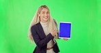 Business woman, tablet and pointing on green screen with tracking markers against a studio background. Portrait of happy female with touchscreen mockup display or call me for advertising or marketing