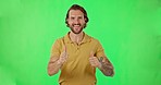 Man, dance and thumbs up by green screen with face, excited and happy for success, agreement and goal. Male dancer, hand gesture and portrait with happiness, celebration and yes sign by background